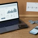 Laptop with a generic payout form beside a bank card, digital wallet device and cryptocurrency tokens